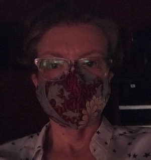 MaryAnn Johanson, masked at a movie