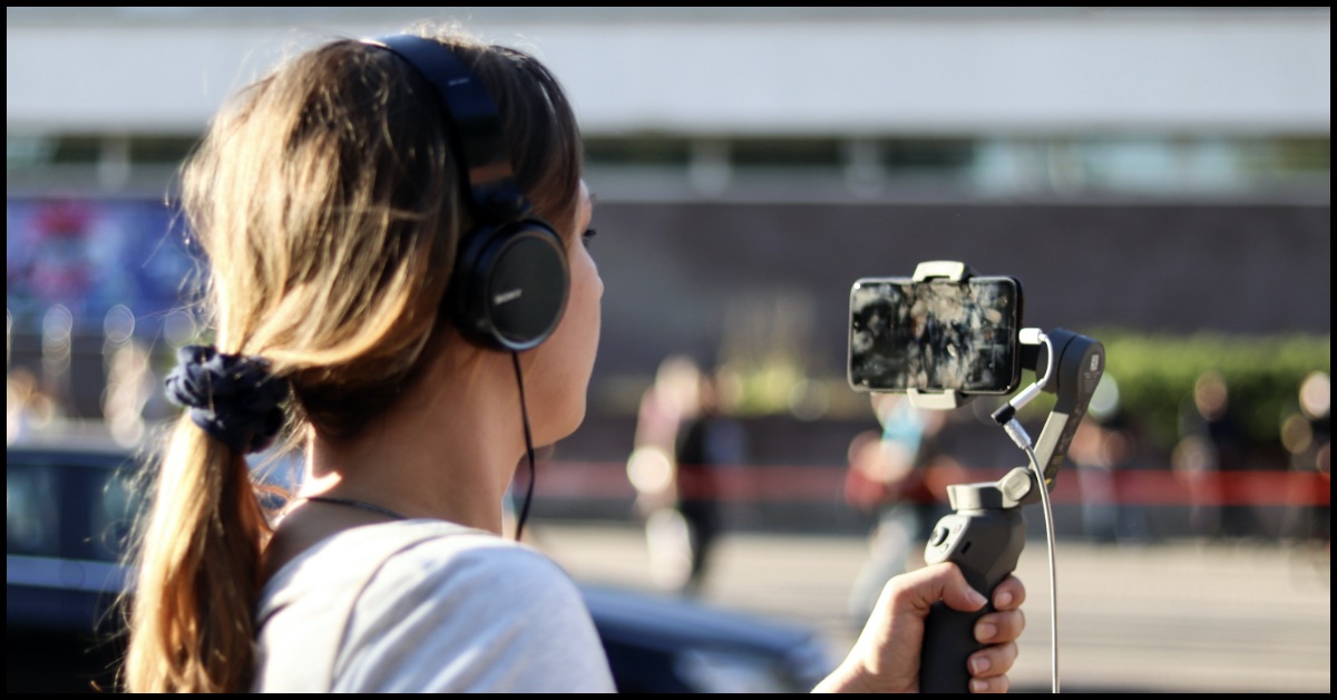A woman shoots a movie with a mobile phone.